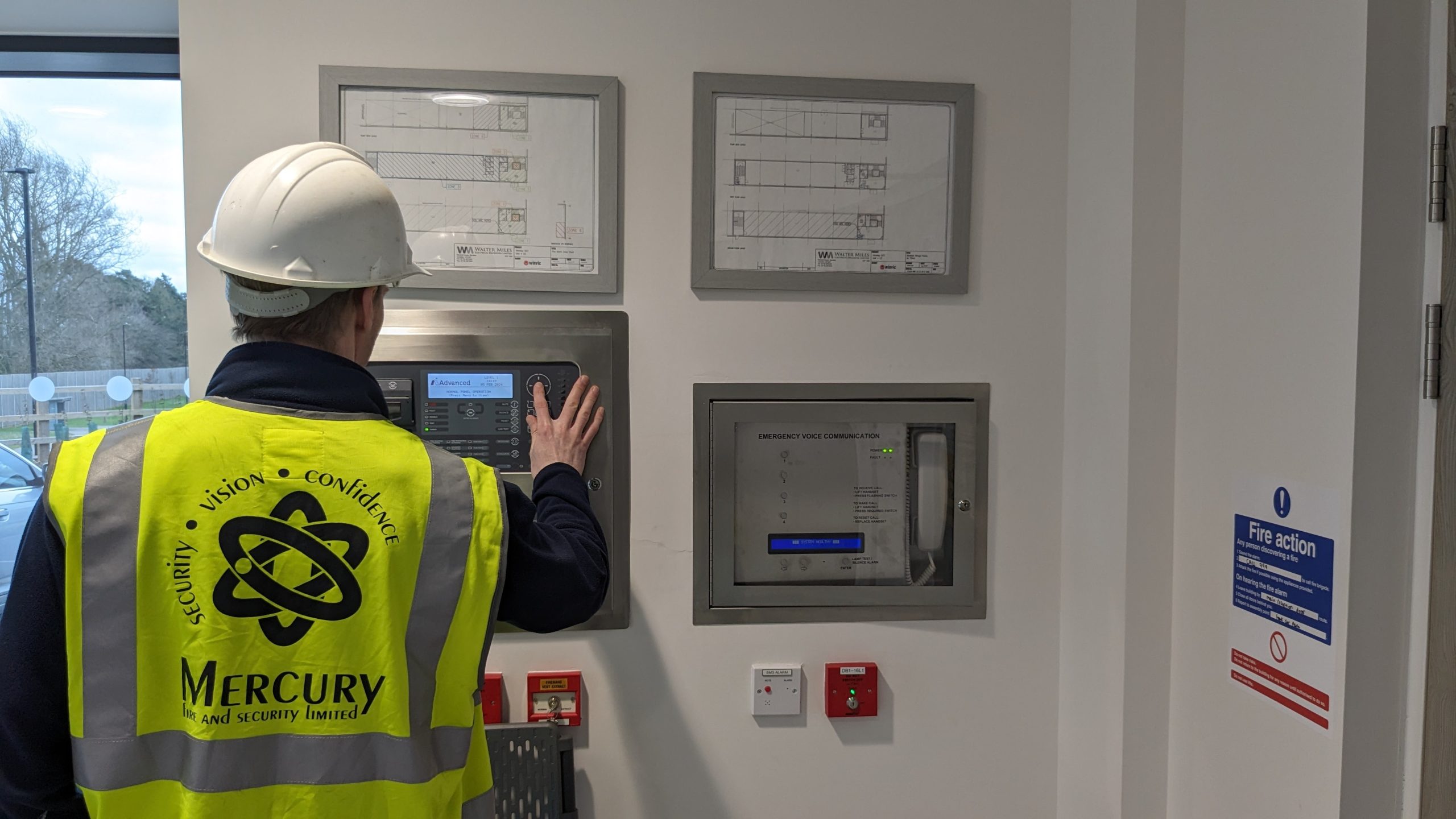 A Mercury employee completes a commercial fire alarm installation