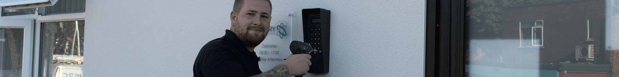 A Mercury engineer installs a door intercom system