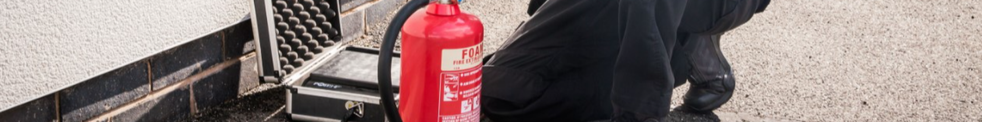 A Mercury employee installs a fire extinguisher